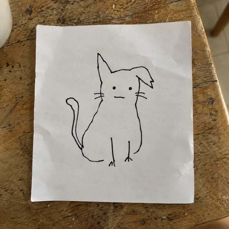 Studio concept: a crooked-eared cat doodle on a scrap of paper