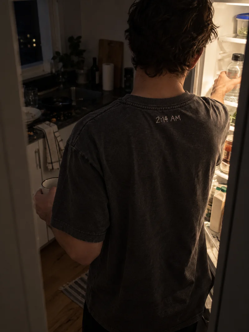 Studio concept: a quiet late-night kitchen view from behind, lit by an open fridge