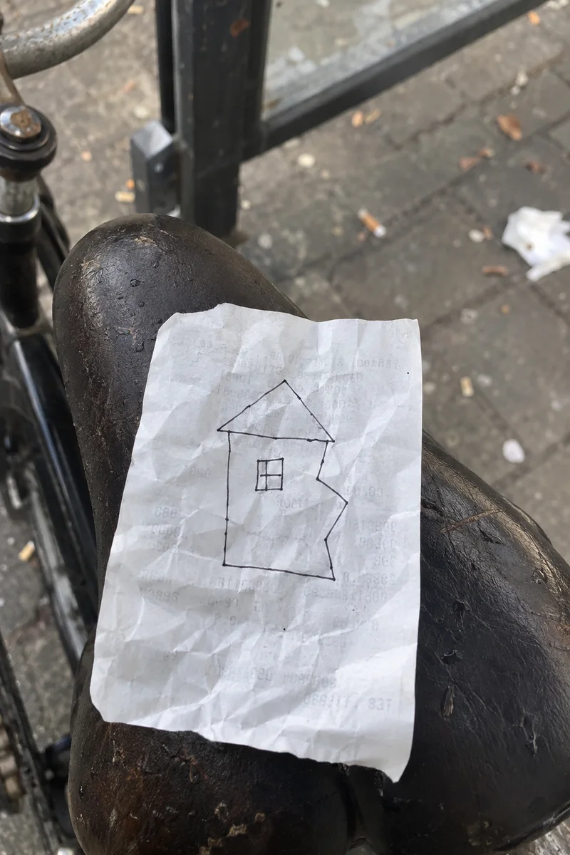 Studio concept: a crumpled receipt with a lopsided house and an ugly kink in its right wall