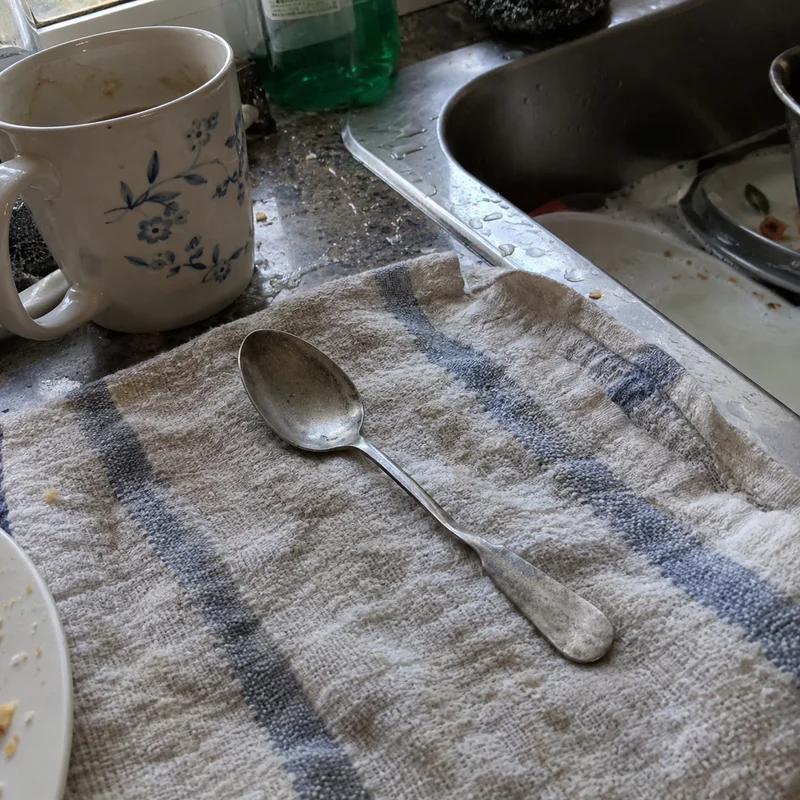 Studio concept: a worn old teaspoon with a small bowl and a kinked narrow handle
