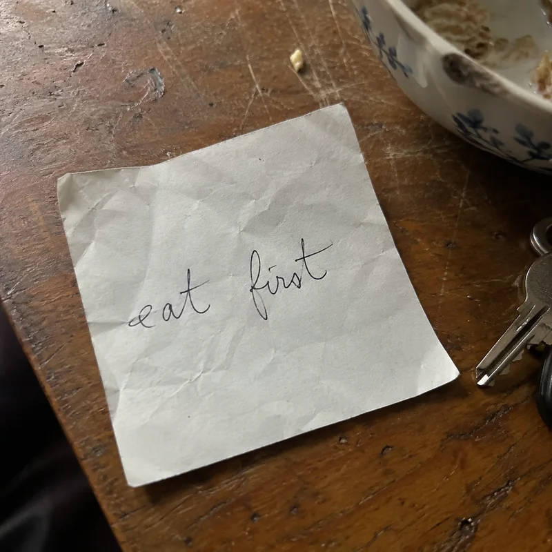 Studio concept: a creased family note with the handwritten words eat first