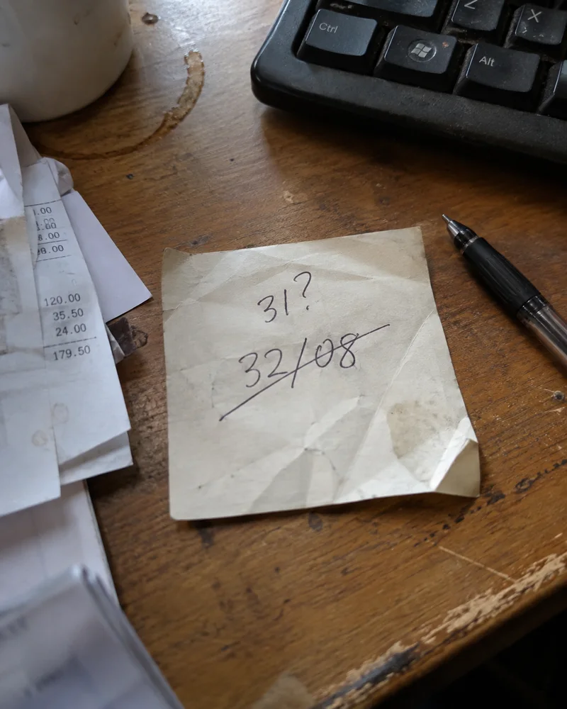 Studio concept: a crossed-out wrong date on a creased work note