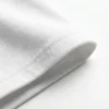 Double-stitched sleeve cuff detail of the Blnk premium oversized blank t-shirt in white.